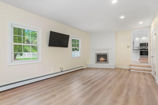 31 Elizabeth St, Shelton, CT 06484 - unfurnished living room featuring light wood-style floors, plenty of natural light, baseboard heating, recessed lighting, and a brick fireplace