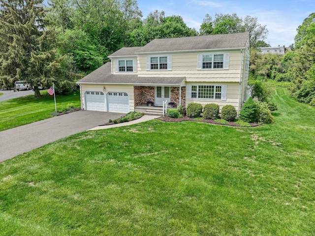 31 Elizabeth St, Shelton, CT 06484 - view of front of house featuring driveway, a front lawn, and a garage