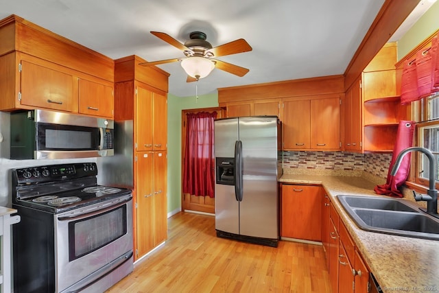 38 Craig Ave, Southington, CT 06489 - kitchen featuring appliances with stainless steel finishes, a sink, light wood-style floors, and brown cabinets