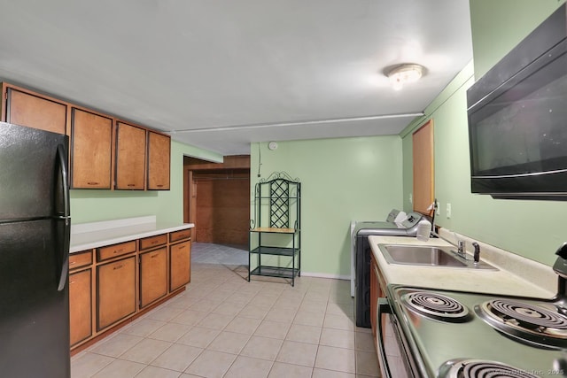 38 Craig Ave, Southington, CT 06489 - kitchen with black appliances, brown cabinetry, a sink, and light tile patterned floors