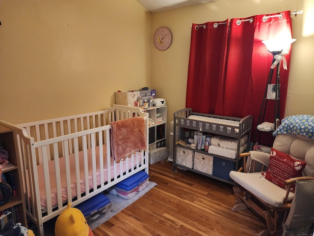 4 Lynn Ln, Windsor Locks, CT 06096 - bedroom featuring wood finished floors and a crib