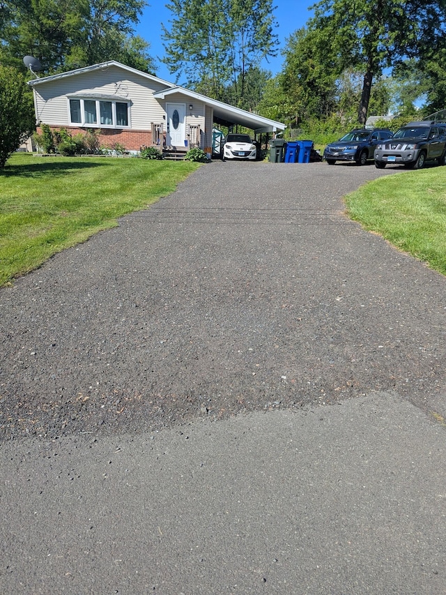 4 Lynn Ln, Windsor Locks, CT 06096 - view of front of home featuring brick siding, a carport, a front lawn, and driveway