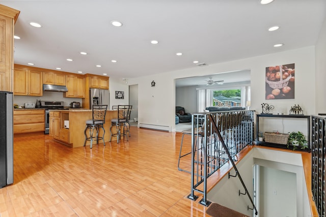 3657 Park Ave, Fairfield, CT 06825 - kitchen with stainless steel appliances, under cabinet range hood, open floor plan, recessed lighting, and a center island