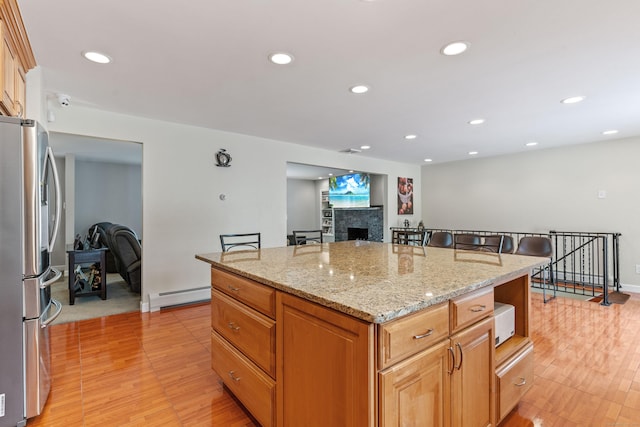 3657 Park Ave, Fairfield, CT 06825 - kitchen featuring freestanding refrigerator, baseboard heating, light wood finished floors, a tile fireplace, and recessed lighting