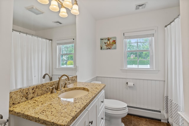3657 Park Ave, Fairfield, CT 06825 - bathroom with a baseboard heating unit, wainscoting, plenty of natural light, vanity, and tile patterned floors