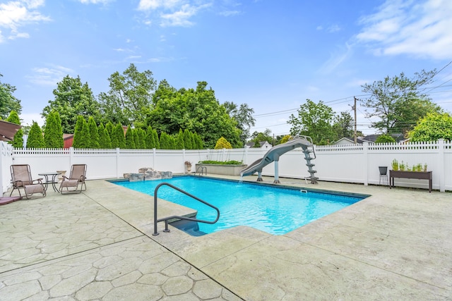 3657 Park Ave, Fairfield, CT 06825 - view of pool with a water slide, a patio, and a fenced backyard