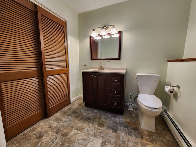 176 Hanover Rd, Newtown, CT 06470 - half bath featuring a baseboard heating unit, stone finish flooring, toilet, and vanity