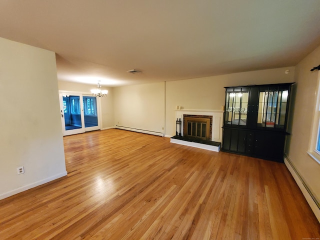 176 Hanover Rd, Newtown, CT 06470 - unfurnished living room featuring a baseboard radiator, a chandelier, and light wood-style flooring