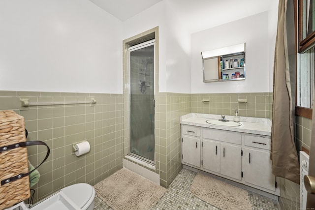 408 Reservoir Rd, Southbury, CT 06488 - bathroom featuring tile walls, a shower stall, tile patterned floors, vanity, and toilet