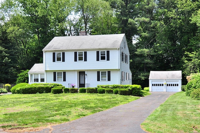 27 Prospect St, Bloomfield, CT 06002 - colonial inspired home with an outdoor structure, a chimney, a detached garage, and a front lawn