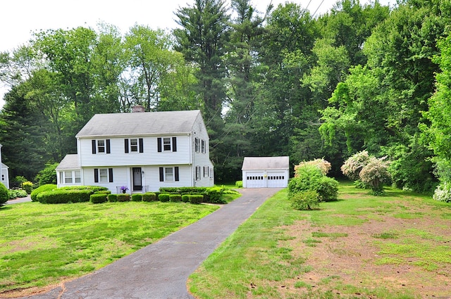 27 Prospect St, Bloomfield, CT 06002 - colonial-style house featuring an outdoor structure, a chimney, a front lawn, and a garage