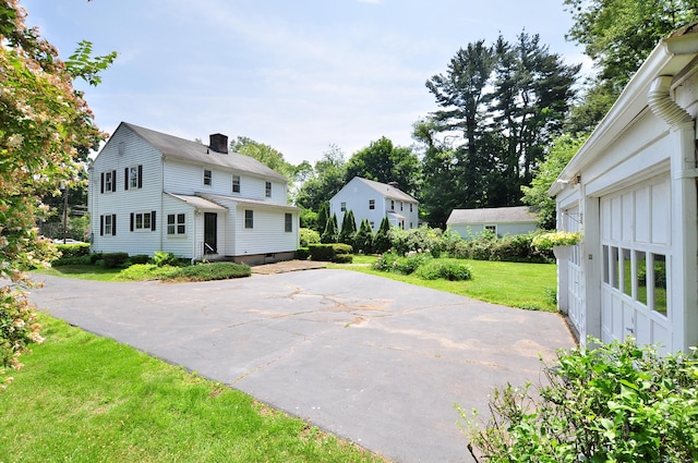 27 Prospect St, Bloomfield, CT 06002 - view of front of property featuring a chimney and a front lawn