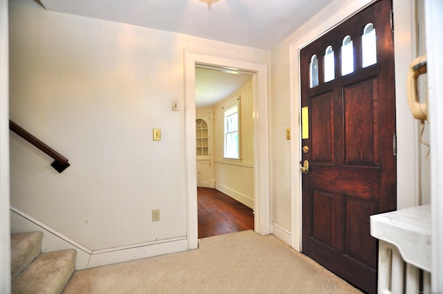 27 Prospect St, Bloomfield, CT 06002 - foyer entrance with carpet, stairs, and baseboards