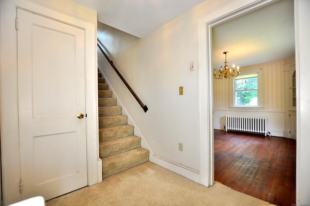 27 Prospect St, Bloomfield, CT 06002 - staircase featuring radiator heating unit, a chandelier, baseboards, and carpet floors