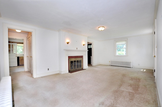 27 Prospect St, Bloomfield, CT 06002 - unfurnished living room featuring radiator heating unit, crown molding, a brick fireplace, carpet flooring, and baseboards