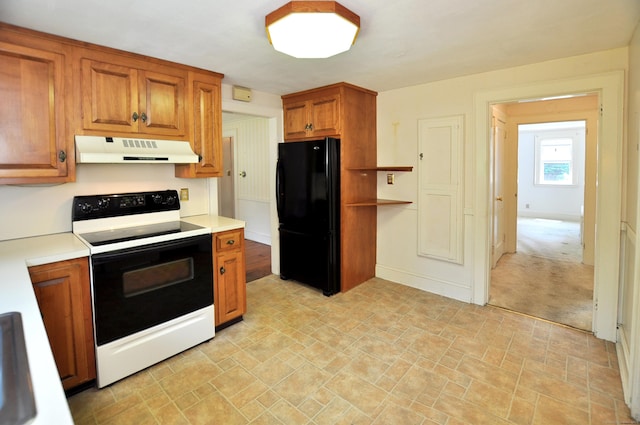 27 Prospect St, Bloomfield, CT 06002 - kitchen with range with electric stovetop, under cabinet range hood, freestanding refrigerator, brown cabinets, and light countertops