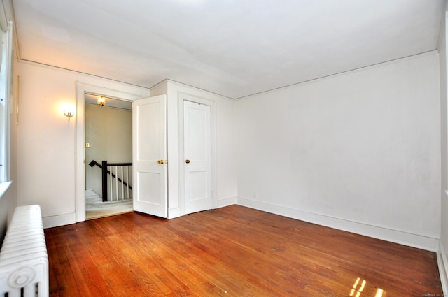 27 Prospect St, Bloomfield, CT 06002 - spare room featuring radiator heating unit, wood finished floors, and baseboards
