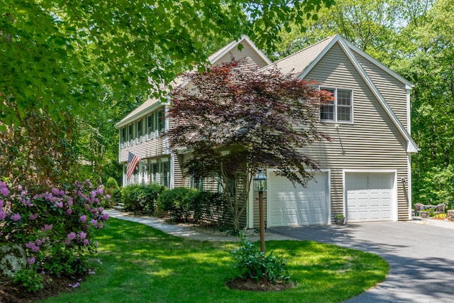 113 Charles St, Tolland, CT 06084 - view of front facade featuring an attached garage, driveway, and a front lawn