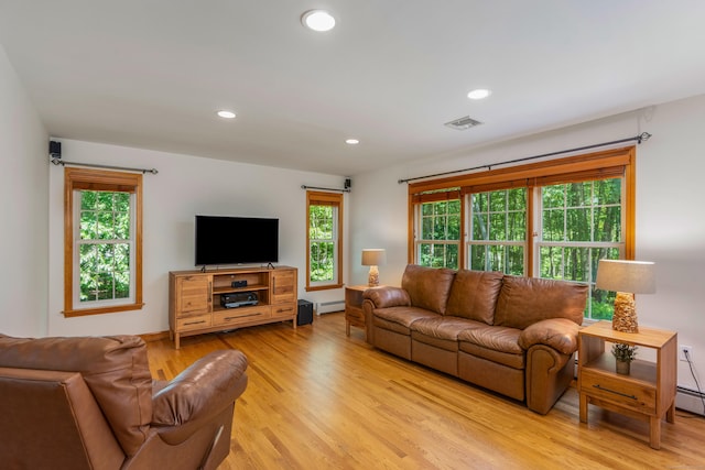 113 Charles St, Tolland, CT 06084 - living area featuring baseboard heating, light wood-style floors, and recessed lighting