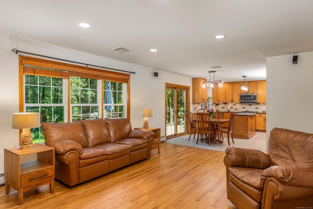 113 Charles St, Tolland, CT 06084 - living area with light wood finished floors, healthy amount of natural light, and recessed lighting