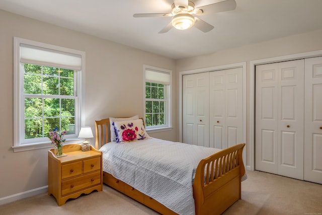 113 Charles St, Tolland, CT 06084 - bedroom with light carpet, multiple windows, multiple closets, and baseboards