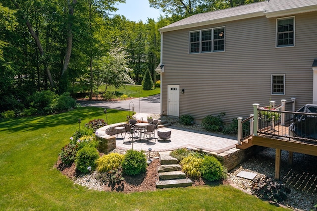 113 Charles St, Tolland, CT 06084 - rear view of house featuring a lawn, a patio area, and a wooden deck