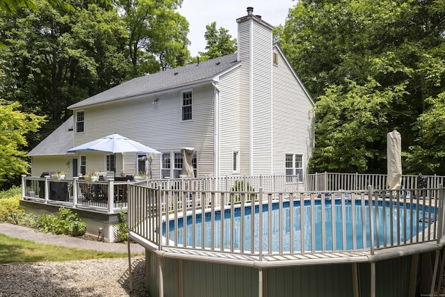 613 Ridgewood Rd, Middletown, CT 06457 - view of swimming pool featuring a wooden deck and view of wooded area