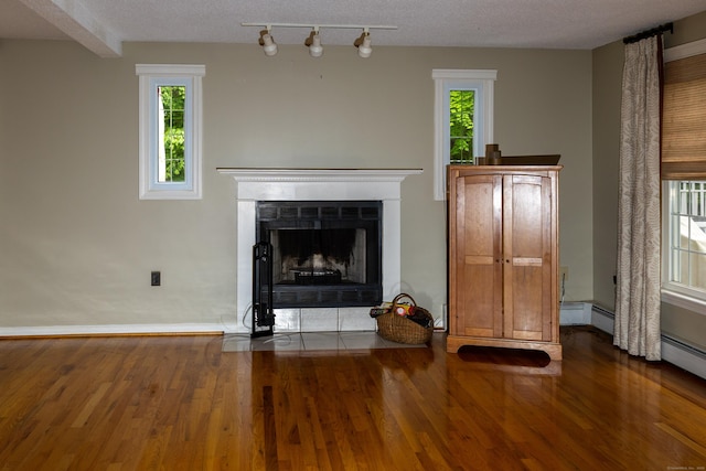 613 Ridgewood Rd, Middletown, CT 06457 - unfurnished living room with wood finished floors, plenty of natural light, a fireplace with flush hearth, and track lighting