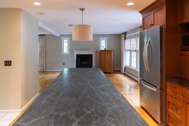 613 Ridgewood Rd, Middletown, CT 06457 - kitchen with freestanding refrigerator, dark countertops, light wood-style flooring, brown cabinetry, and recessed lighting