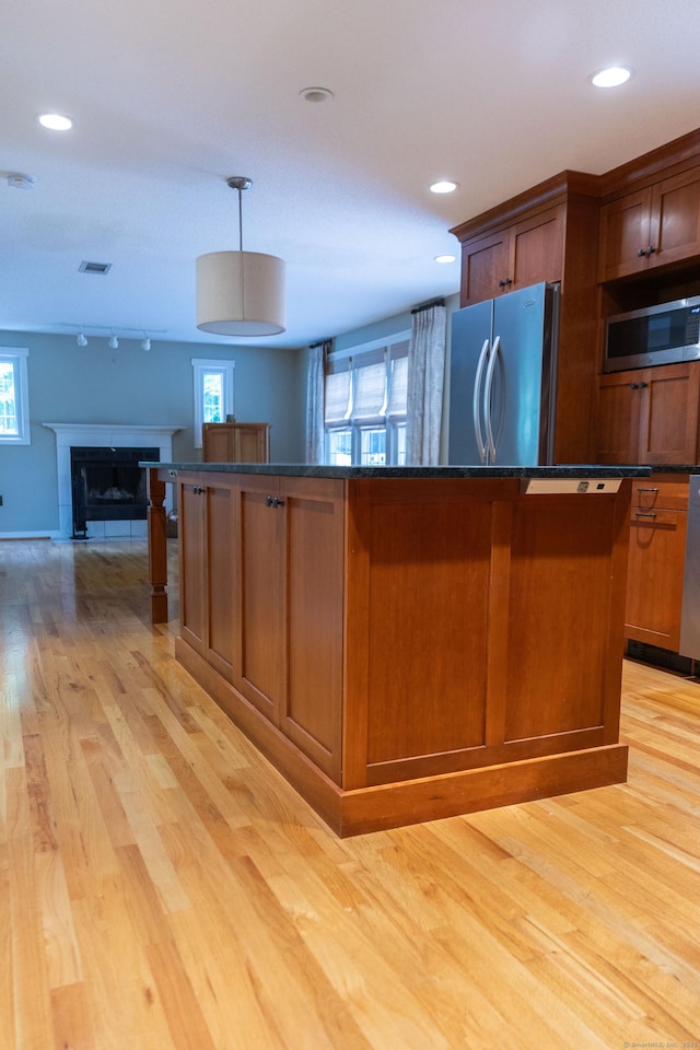 613 Ridgewood Rd, Middletown, CT 06457 - kitchen featuring stainless steel appliances, light wood-style flooring, a kitchen island, open floor plan, and hanging light fixtures