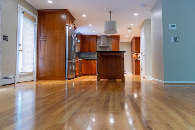 613 Ridgewood Rd, Middletown, CT 06457 - kitchen featuring freestanding refrigerator, wall chimney exhaust hood, dark countertops, light wood-type flooring, and backsplash