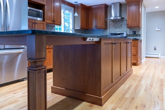 613 Ridgewood Rd, Middletown, CT 06457 - kitchen with wall chimney exhaust hood, appliances with stainless steel finishes, a baseboard heating unit, dark countertops, and light wood-style floors