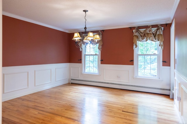 613 Ridgewood Rd, Middletown, CT 06457 - unfurnished dining area featuring a baseboard heating unit, a wainscoted wall, ornamental molding, a chandelier, and light wood-type flooring