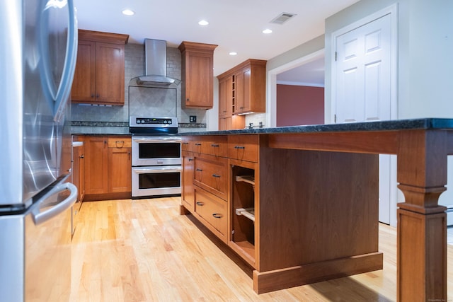 613 Ridgewood Rd, Middletown, CT 06457 - kitchen featuring stainless steel appliances, wall chimney exhaust hood, backsplash, light wood-type flooring, and recessed lighting