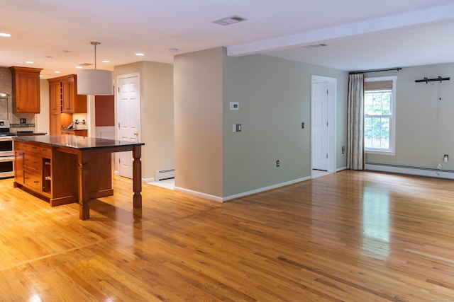 613 Ridgewood Rd, Middletown, CT 06457 - kitchen featuring brown cabinetry, dark countertops, a baseboard heating unit, light wood-type flooring, and recessed lighting