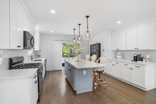 37 Highgate Rd, Trumbull, CT 06611 - kitchen with gas range, black microwave, a sink, a breakfast bar area, and recessed lighting