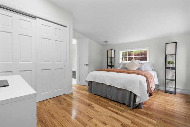 182 5th St, Stamford, CT 06905 - bedroom featuring vaulted ceiling, light wood-style flooring, a closet, and baseboards