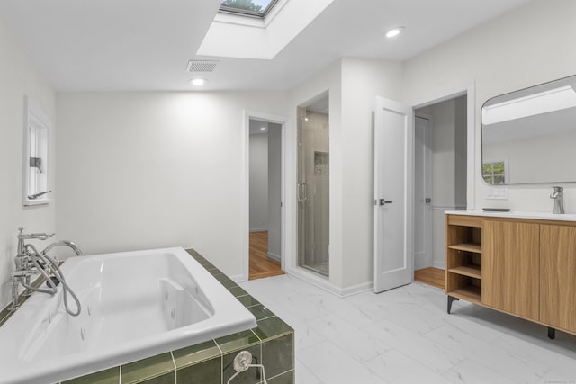 182 5th St, Stamford, CT 06905 - bathroom featuring a skylight, a jetted tub, vanity, a shower stall, and marble finish flooring