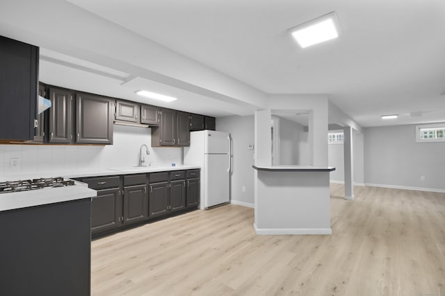 182 5th St, Stamford, CT 06905 - kitchen featuring freestanding refrigerator, light wood-style flooring, light countertops, and baseboards