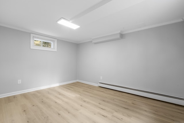 182 5th St, Stamford, CT 06905 - basement with wood finished floors, a baseboard heating unit, ornamental molding, and baseboards