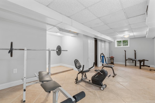 182 5th St, Stamford, CT 06905 - workout room with light tile patterned floors, a paneled ceiling, and baseboards