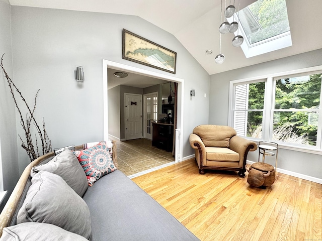 273 New London Rd, Colchester, CT 06415 - living area featuring lofted ceiling, a skylight, baseboards, and wood finished floors