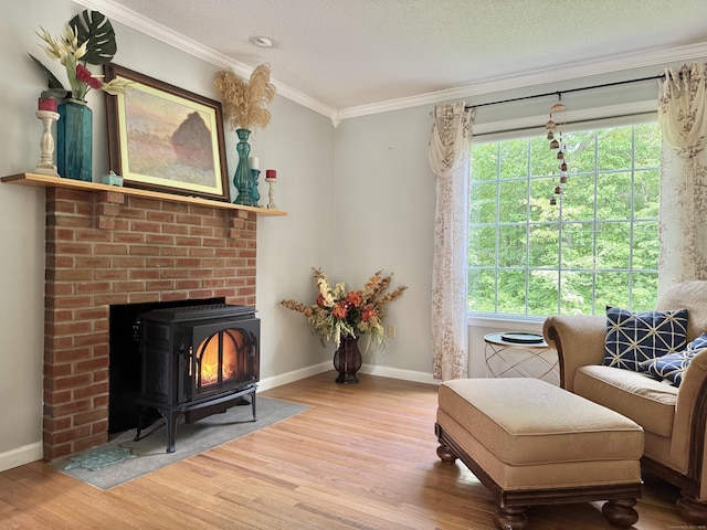 273 New London Rd, Colchester, CT 06415 - sitting room featuring wood finished floors, crown molding, a wood stove, baseboards, and a textured ceiling