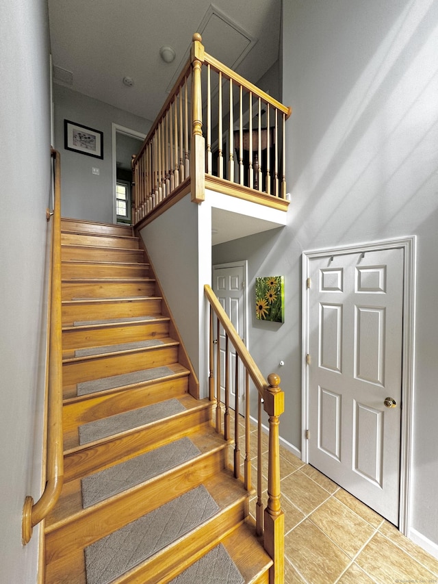273 New London Rd, Colchester, CT 06415 - stairway with baseboards, tile patterned flooring, and a high ceiling