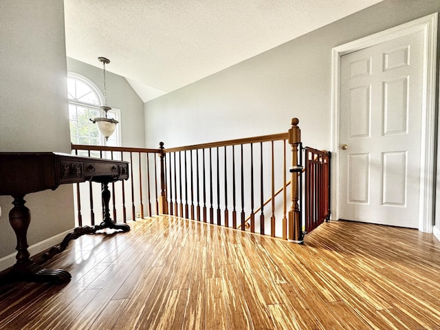 273 New London Rd, Colchester, CT 06415 - hall with hardwood / wood-style floors, an upstairs landing, and vaulted ceiling