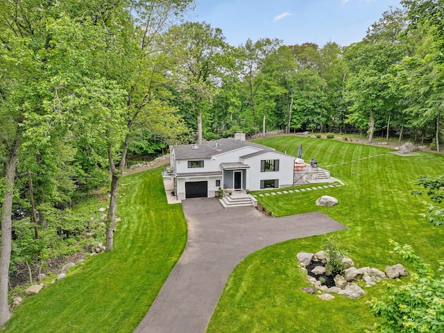 23 Wyndover Ln N, Stamford, CT 06902 - view of front of property featuring driveway, an attached garage, a chimney, and a front lawn