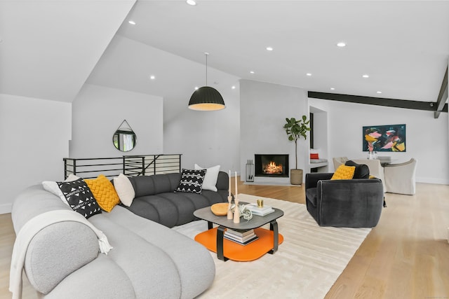 23 Wyndover Ln N, Stamford, CT 06902 - living room with light wood-style flooring, vaulted ceiling, recessed lighting, a lit fireplace, and baseboards