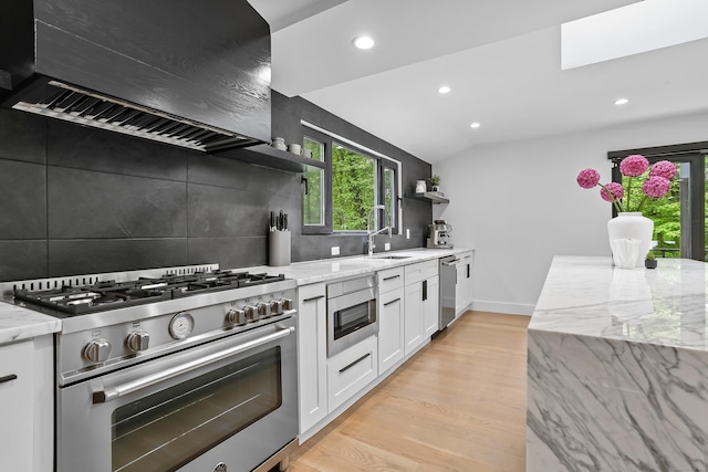 23 Wyndover Ln N, Stamford, CT 06902 - kitchen featuring stainless steel appliances, open shelves, premium range hood, a sink, and light stone counters