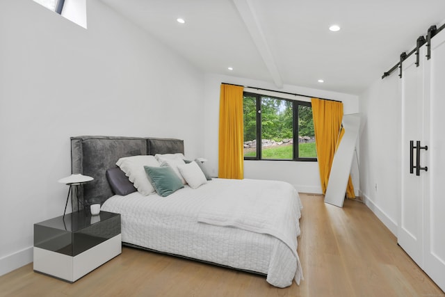 23 Wyndover Ln N, Stamford, CT 06902 - bedroom featuring a barn door, wood finished floors, recessed lighting, beamed ceiling, and baseboards