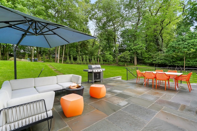 23 Wyndover Ln N, Stamford, CT 06902 - view of patio with area for grilling, an outdoor living space with a fire pit, outdoor dining space, and view of wooded area